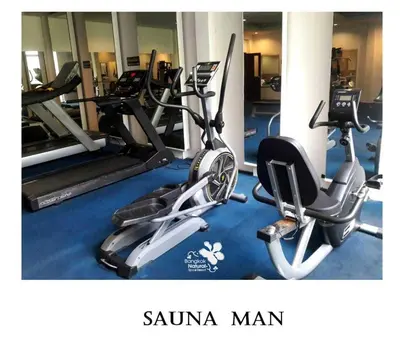 a gym with two treadmills and two exercise bikes at Palette Bangkok Natural Resort and Spa in Bangkok