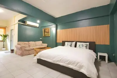 a bedroom with a large bed and a couch at xx GO INN Grand Palace - โก อินน์ พระบรมมหาราชวัง เจริญกรุง 1 in Bangkok
