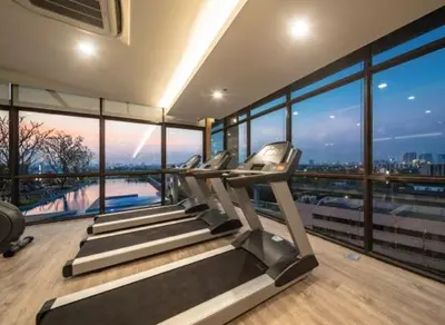 a gym with treadmills and a view of the city at Convenient 1 bed condo Hua Mak in Sathani Ban Hua Mak