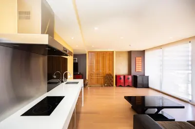 a kitchen with a stove and a counter top at Beautiful 1 bed with huge Lumpini park view in Bangkok