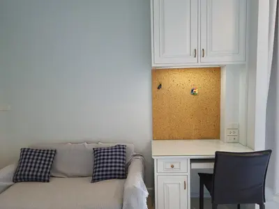 a living room with a couch and a table and cabinets at Spacious 3 Ensuite Bedrooms Townhouse in Rama 3, Bangkok in Bangkok