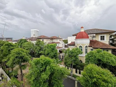 a large building with a red roof and trees at Spacious 3 Ensuite Bedrooms Townhouse in Rama 3, Bangkok in Bangkok