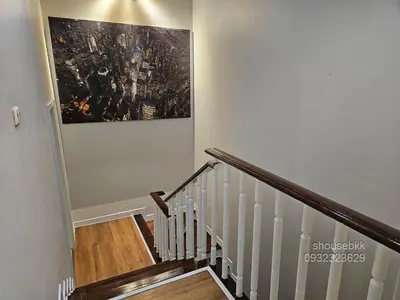 a staircase with a painting on the wall at Spacious 3 Ensuite Bedrooms Townhouse in Rama 3, Bangkok in Bangkok