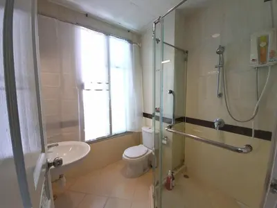 a bathroom with a shower and a toilet and a sink at Spacious 3 Ensuite Bedrooms Townhouse in Rama 3, Bangkok in Bangkok