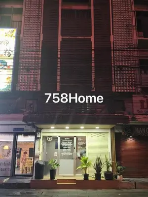 a store front of a building with potted plants in front at Huai Khwang Townhome in Ban Na Song