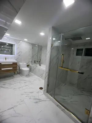 a bathroom with a shower and a toilet and a sink at Huai Khwang Townhome in Ban Na Song
