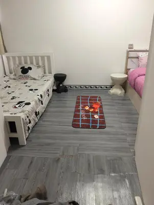 a bedroom with a bed and a rug on the floor at อิมแพ็ค คอนโดเมืองทอง in Thung Si Kan