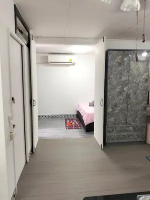 a room with a door leading to a bedroom at อิมแพ็ค คอนโดเมืองทอง in Thung Si Kan