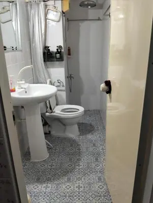 a bathroom with a toilet and a sink at อิมแพ็ค คอนโดเมืองทอง in Thung Si Kan