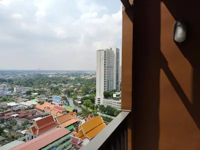 a view of a city from the balcony of a building at Apartment in Thon Buri 0 meter From BTS station in Bang Khun Thian