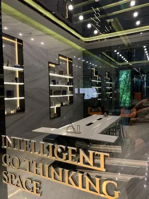 a room with a desk and a sign that reads intelligent space influencing at 2 Bed 2 Bath Condo Steps to BTS&MRT in Bangkok