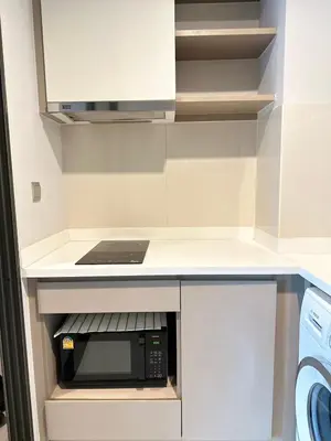a kitchen with a counter with a microwave oven at 2 Bed 2 Bath Condo Steps to BTS&MRT in Bangkok