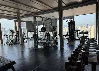 a gym with several tread machines in a building at Thonglor Ekkamai 10 mins Sky Pool 1BR in Bangkok