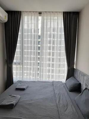 a bedroom with a bed and a large window at Thonglor Ekkamai 10 mins Sky Pool 1BR in Bangkok