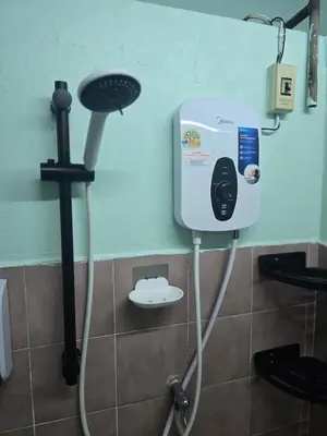 a shower in a bathroom with a hair dryer at 103 Lovely AC apartment with private kitchen in Bangkok