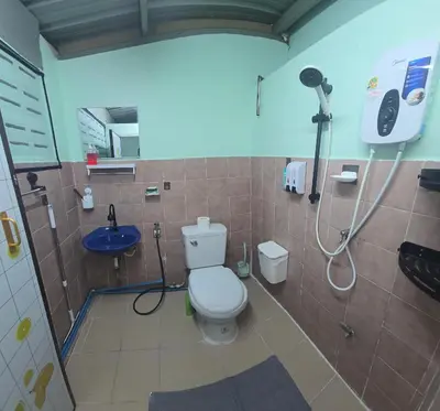 a bathroom with a toilet and a shower and a sink at 103 Lovely AC apartment with private kitchen in Bangkok