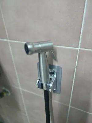 a metalaucet on a wall in a bathroom at 103 Lovely AC apartment with private kitchen in Bangkok