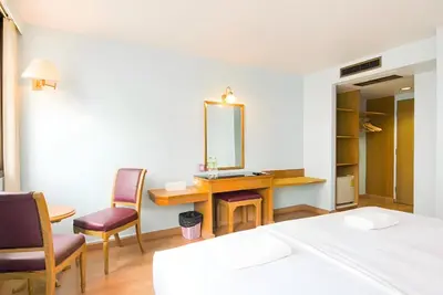 a bedroom with a desk and chairs and a mirror at xx Wish Inn Chidlom - Ratchadamri 2 in Pratunam