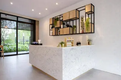 a lobby with a reception desk with a large window at 2BR Modern Condo Office Room Sofa Bed Pool Gym in Bangkok