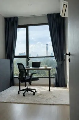 an office with a desk and a chair in front of a window at 2BR Modern Condo Office Room Sofa Bed Pool Gym in Bangkok