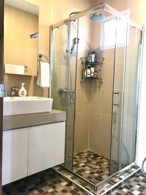 a bathroom with a shower and a sink at Cozy and Convenient Bangna House in Ban Khlong Samrong