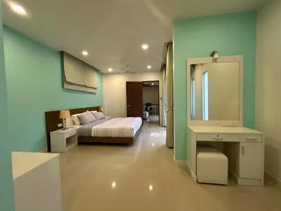 a bedroom with a bed and a mirror at Cozy and Convenient Bangna House in Ban Khlong Samrong