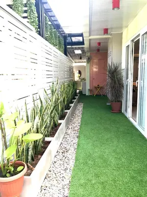 an office corridor with green grass and plants at Cozy and Convenient Bangna House in Ban Khlong Samrong
