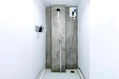 a shower stall in a bathroom with a hose at XX Mitr Inn Sukhumvit Soi 2 - มิตร อินน์ สุขุมวิท ซอย 2 BTS Nana in Bang Kapi