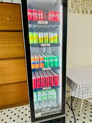 a refrigerator full of soda and sodas at BKK Rama3 Guest House in Bangkok