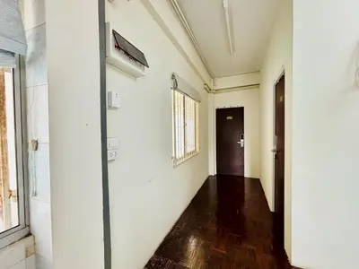 an empty hallway in an old building with a door at BKK Rama3 Guest House in Bangkok