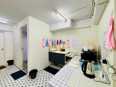 a kitchen with a sink and a counter in a room at BKK Rama3 Guest House in Bangkok