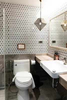 a bathroom with a toilet and a sink at Tints of Blue Hotel in Bangkok