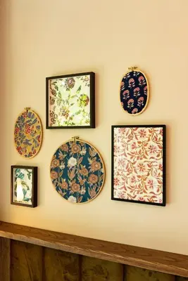 a wall with four plates on a wall at Tints of Blue Hotel in Bangkok