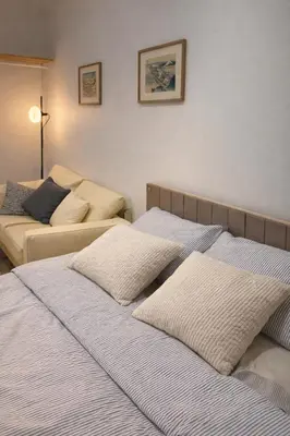 two beds sitting next to each other in a room at Cozy Japandi Stay on Sukhumvit in Bangkok