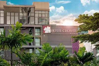a hotel sign on the side of a building at Hotel Clover Asoke - SHA Extra Plus in Bangkok