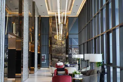 a lobby with couches and chairs in a building at The Politan Aqua in Ban Sai Ma