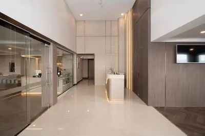 a large bathroom with a sink and a kitchen at SureStay Plus by Best Western Ramkhamhaeng Airport Rail Link Bangkok in Bangkok