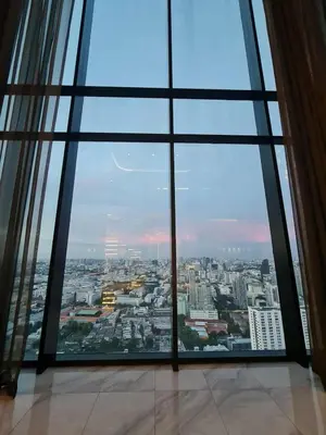 a view of a city through a large window at New Ultra Highend Condo center BKK BTS 4min walk Perfect for Staycation in Bangkok