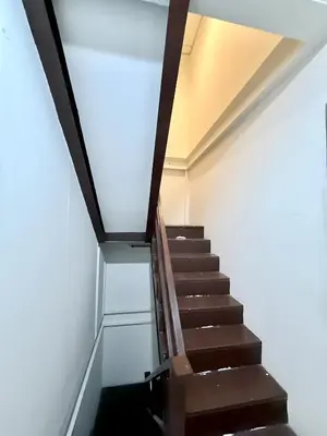 a staircase in a building with a glass floor at xx zNap Khaosan - แสนป ข้าวสาร รามบุตรี in Bang Bua Thong Railway Station