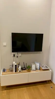 a living room with a large tv on the wall at ห้องพักใจกลางกรุงเทพฯ ใกล้สยาม in Pratunam