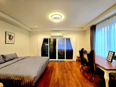 a bedroom with a bed and a desk and a deskablish at The Atlas hostel Bangkok in Thung Si Kan