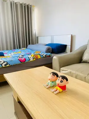 two toy babies sitting on a table in a living room at Pixie Happy Room Popular Condo C5 Cozy Private Room near IMPACT Muangthong in Ban Bang Phang