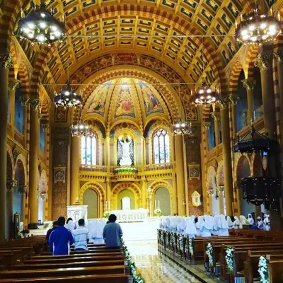 a group of people sitting in a large church at Merge Hostel in Samphanthawong