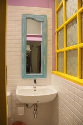 a bathroom with a sink and a mirror at Merge Hostel in Samphanthawong