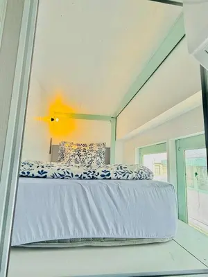 a large bed in a room with a window at Easy Monday Capsule Bed and Traditional Thai Bath in Bangkok
