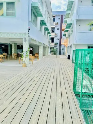 an empty boardwalk in front of a building at Easy Monday Capsule Bed and Traditional Thai Bath in Bangkok
