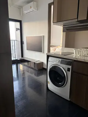 a kitchen with a washing machine on a counter at Private Skyrise view on thonglor in Bangkok