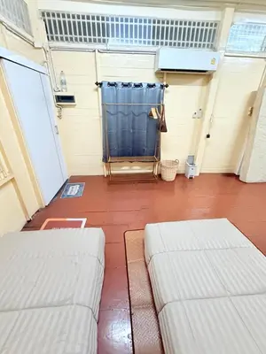 two white couches sitting in a garage at Muzachi home stay and canal in Bangkok Yai