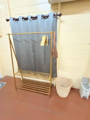 a shower curtain in a room with a basket at Muzachi home stay and canal in Bangkok Yai