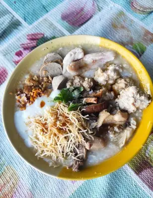a yellow bowl of food on a table at Muzachi home stay and canal in Bangkok Yai